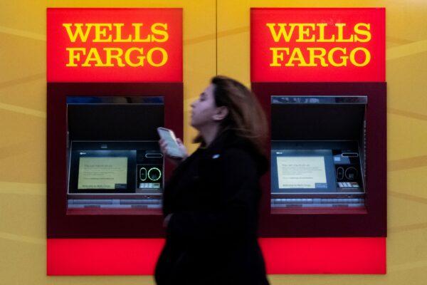 A woman walks past Wells Fargo bank in New York City on March 17, 2020. (Jeenah Moon/Reuters)