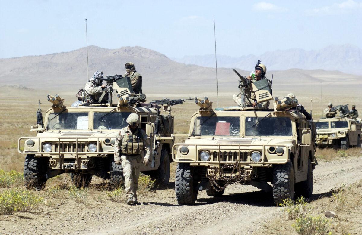 U.S. Special Forces soldiers with Task Force 31 stop their convoy on the way to conduct joint village searches with the Afghan National Army, in southeast Afghanistan, on March 29, 2004. (Darren McCollester/Getty Images)