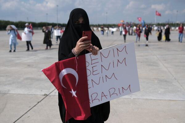 A woman holds a placard reading, "My body, my decision," during a protest against official COVID-19-related mandates including vaccinations, tests, and masks, in Istanbul, Turkey, on Sept. 11, 2021. (Murad Sezer/Reuters)