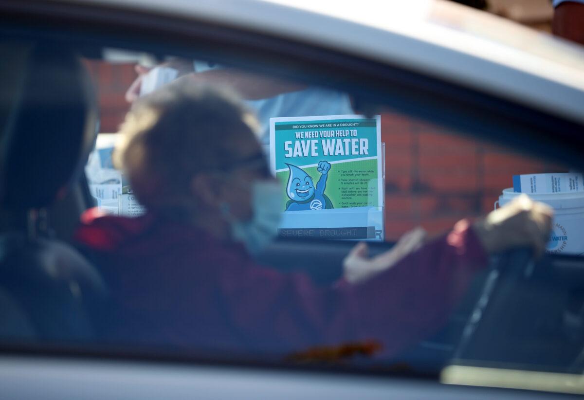 A motorist drives by a sign encouraging water conservation during a "Drought Drive Up" event at the Marin Municipal Water District headquarters in Corte Madera, California, on June 12, 2021. (Justin Sullivan/Getty Images)