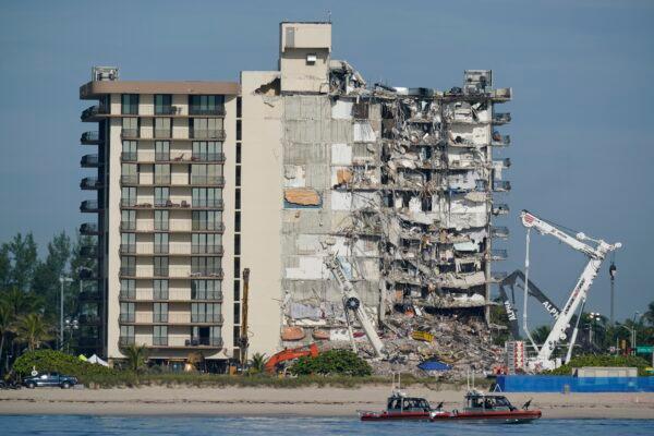 Coast guard boats patrol in front of the partially collapsed Champlain Towers South condo building in Surfside, Fla., on July 1, 2021. (Mark Humphrey/AP Photo)