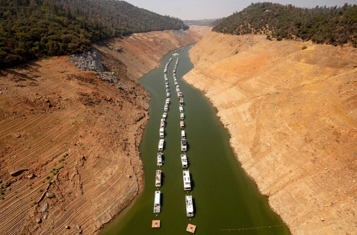 Houseboats sit in a narrow section of water in a depleted Lake Oroville in Oroville, California, on Sept. 5, 2021. (Josh Edelson/AFP via Getty Images)