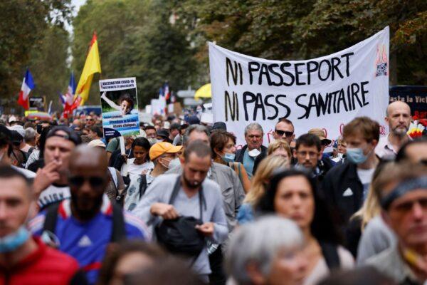 Demonstrators march during a protest against COVID-19 vaccine passports on De Villiers Avenue in Paris on Sept. 11, 2021. The sign reads 'Neither passport nor health pass'. (Thomas Samson/AFP via Getty Images)