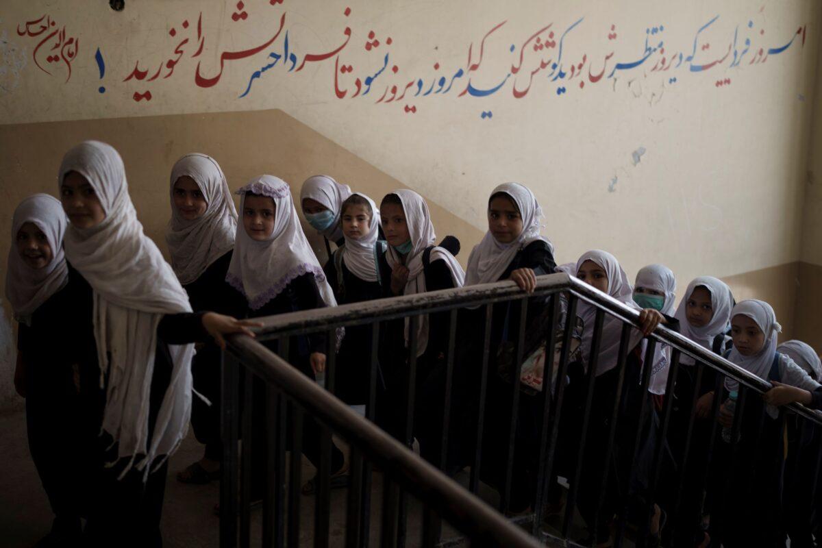 Girls walk upstairs as they enter a school before class in Kabul, Afghanistan on Sept. 12, 2021. (Felipe Dana/AP Photo)