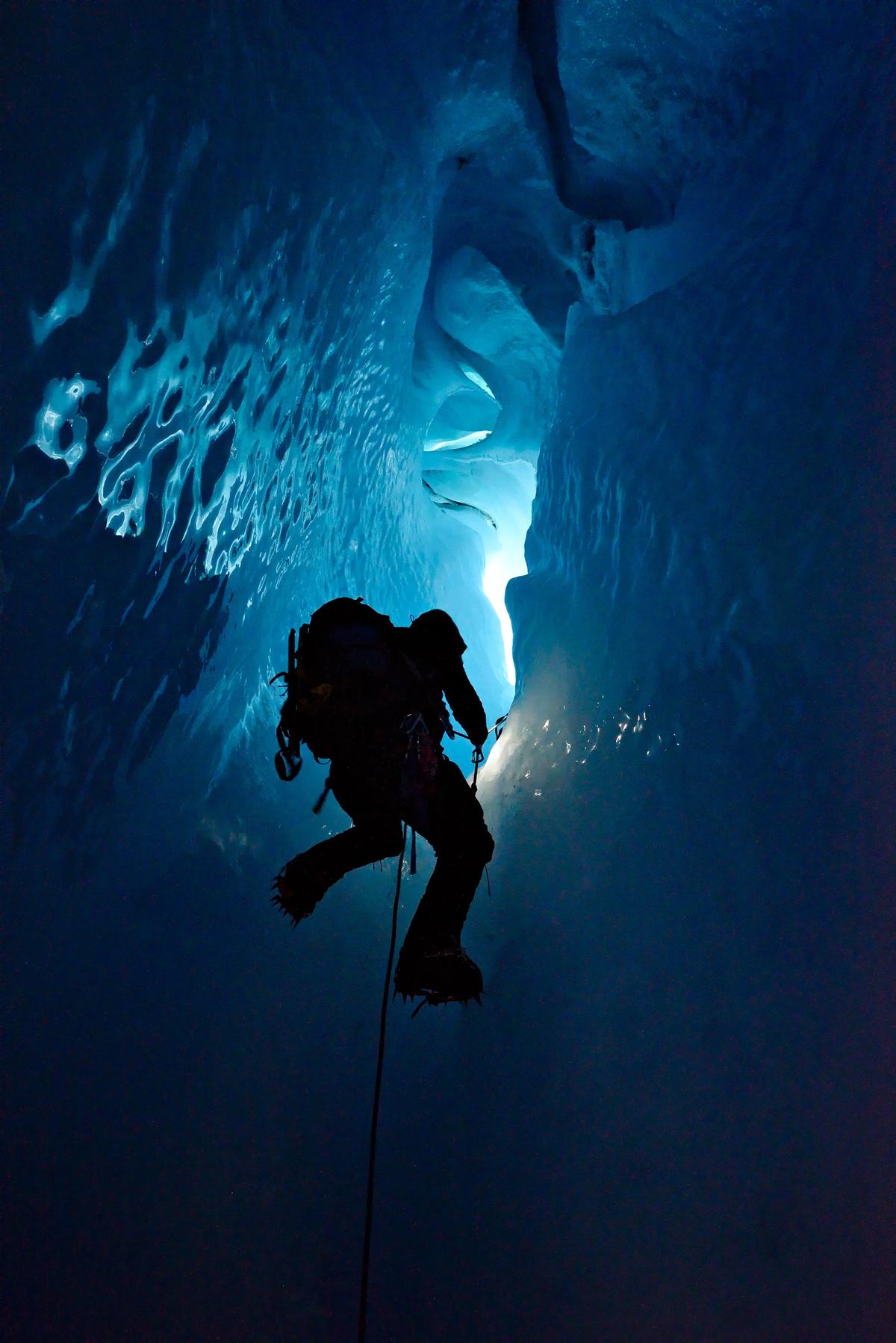 Ascending up the ice cave wall. (Courtesy of Caters News)