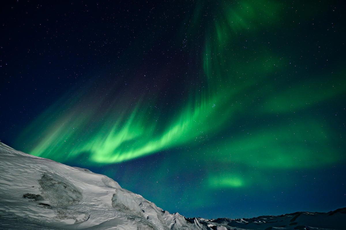 The Northern Lights over the icy landscape. (Courtesy of Caters News)