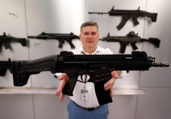 An employee presents a rifle inside a showroom of the Ceska Zbrojovka small arms factory in Uhersky Brod, Czech Republic, on Aug. 31, 2021. (David W Cerny/Reuters)