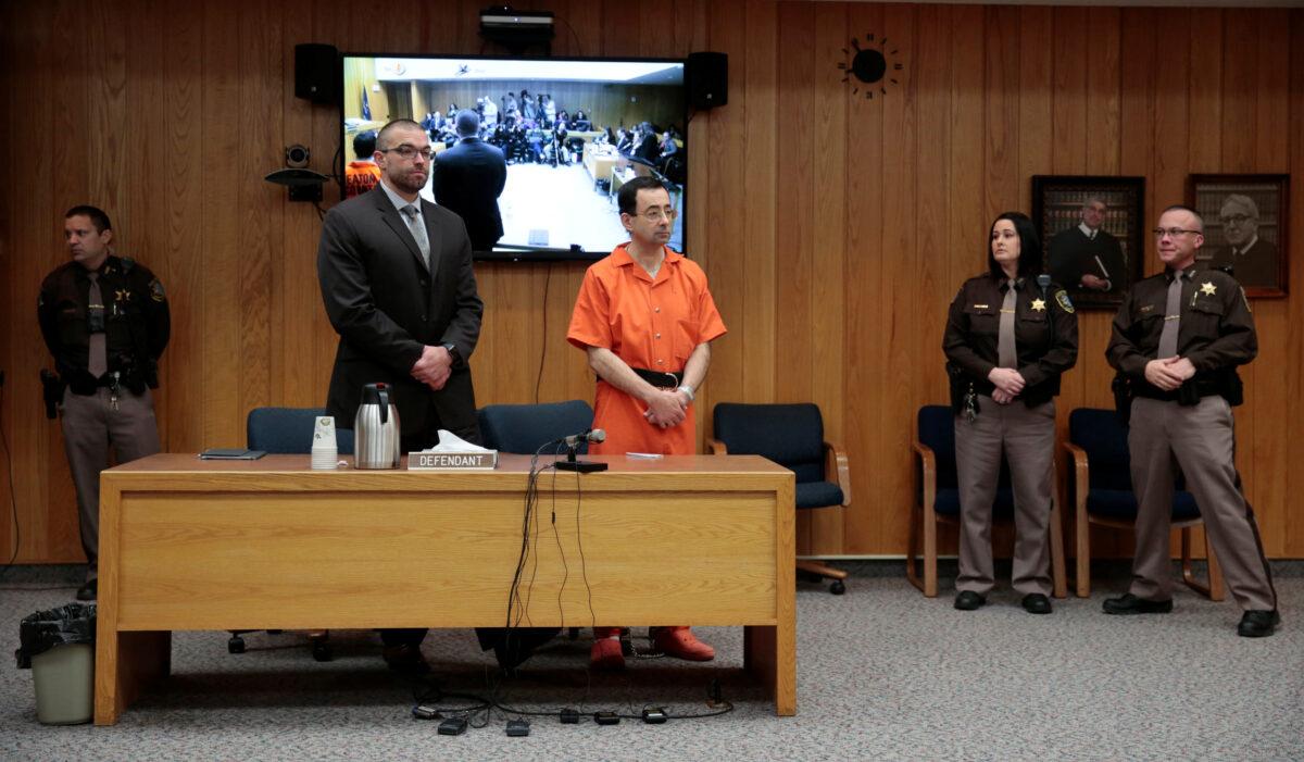 Larry Nassar, a former team USA Gymnastics doctor who pleaded guilty in November 2017 to sexual assault charges, and his defense attorney Matt Newburg stand during Nassar's sentencing hearing in the Eaton County Court in Charlotte, Mich., on Feb. 5, 2018. (Rebecca Cook/Reuters)