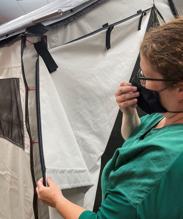 Diamond Brand COO Lauren Rash inspects a prototype of the company's new wall tent, which relies on resin-based zippers and Velcro, at Diamond Brand factory in Fletcher, outside Asheville, N.C., on Aug. 11, 2021. (Howard Schneider/Reuters)