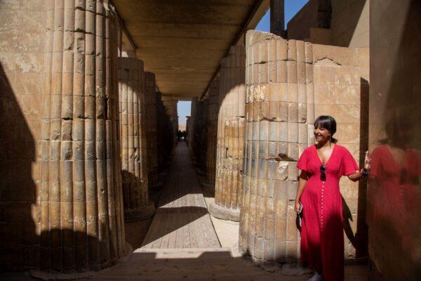 A tourist listens to a guide speak at the entrance of the southern cemetery of King Djoser, after its restoration, near the famed Step Pyramid, in Saqqara, south of Cairo, Egypt, on Sept. 14, 2021. (Nariman El-Mofty/AP Photo)
