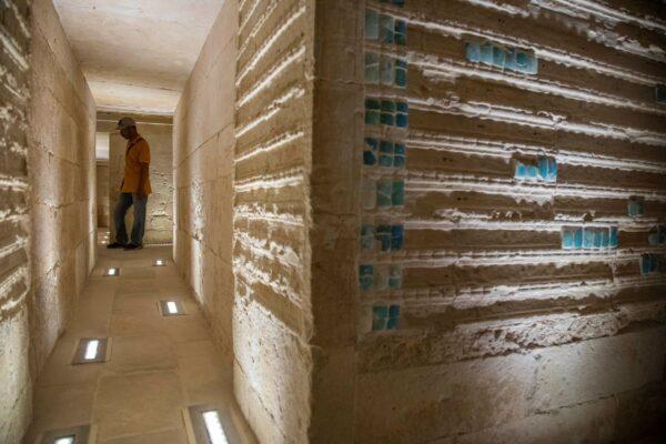 A worker stands inside the southern cemetery of King Djoser, after its restoration, near the famed Step Pyramid, in Saqqara, south of Cairo, Egypt, on Sept. 14, 2021. (Nariman El-Mofty/AP Photo)