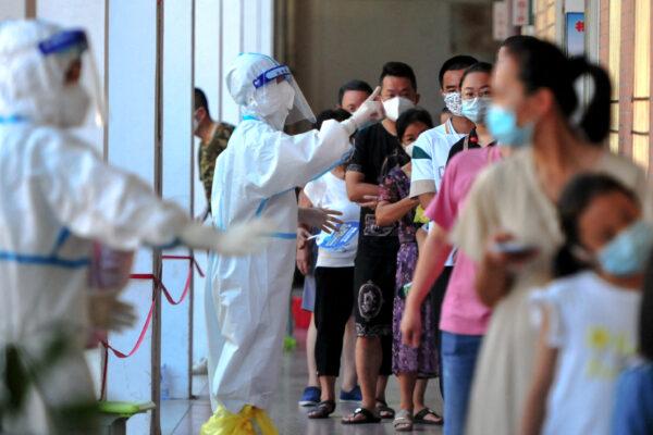 Residents queue to undergo nucleic acid tests for the Covid-19 coronavirus in Xianyou county, Putian city, in China's eastern Fujian province on Sept. 13, 2021.( -/CNS/AFP via Getty Images)