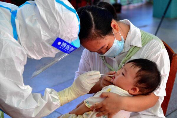 A child undergoes a nucleic acid test for the Covid-19 coronavirus in Putian, Fujian Province, China, on Sept. 13, 2021. (-/CNS/AFP via Getty Images)