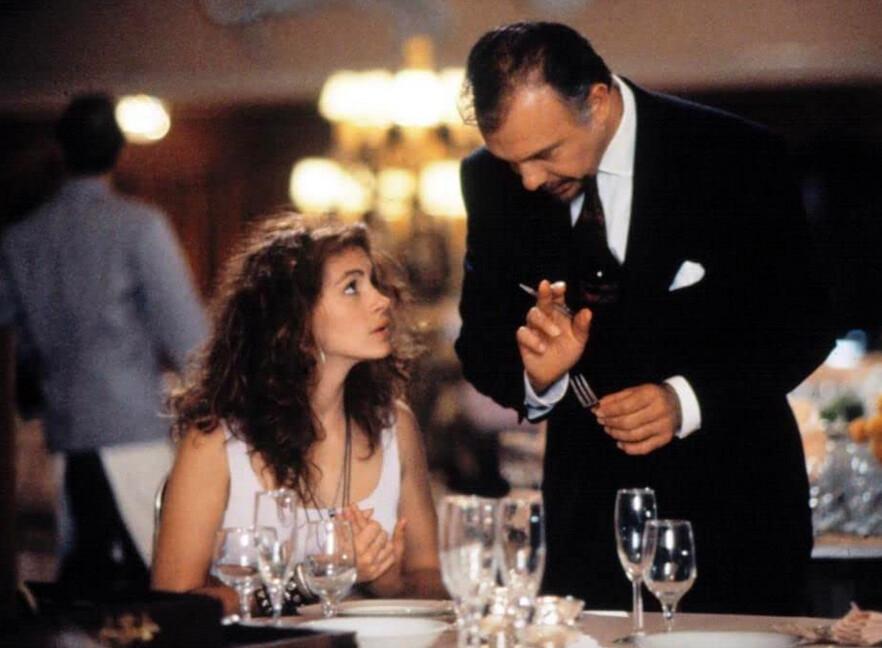 Miss Vivian (Julia Roberts) receives instruction in cutlery identification by the Beverly Wilshire hotel manager (Hector Elizondo), in “Pretty Woman.” (Buena Vista Pictures/Touchstone Pictures)