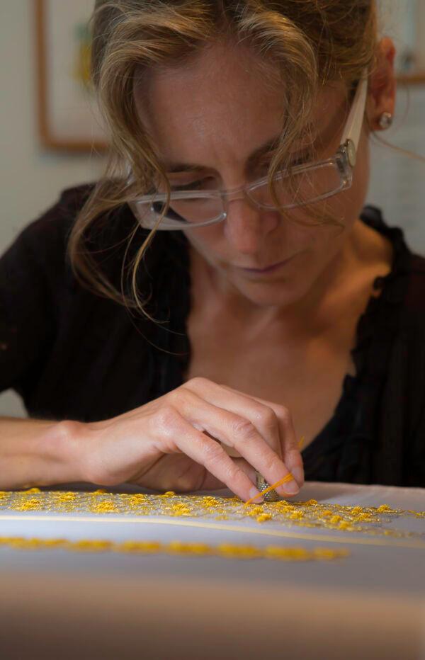 Master Artist, gold-thread embrioderer Sylvie Deschamps at work. (Guerlain/Courtesy of Le Bégonia d'Or)