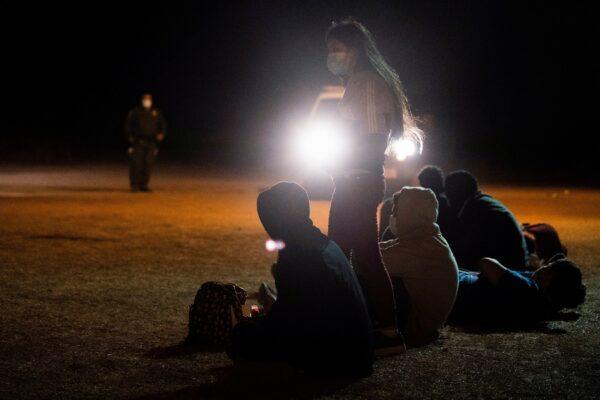 Unaccompanied illegal immigrant children wait to be transported by the U.S. Border Patrol after crossing the Rio Grande River into the United States from Mexico in La Joya, Texas, on April 7, 2021. (Go Nakamura/Reuters)