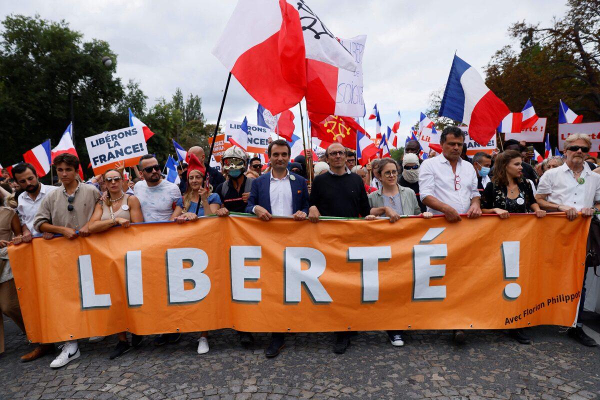 Leader of French nationalist party "Les Patriotes" (The Patriots) Florian Philippot (C) leads the march during a demonstration against France's COVID-19 health pass in Paris on Sept. 11, 2021. (Thomas Samson/AFP via Getty Images)
