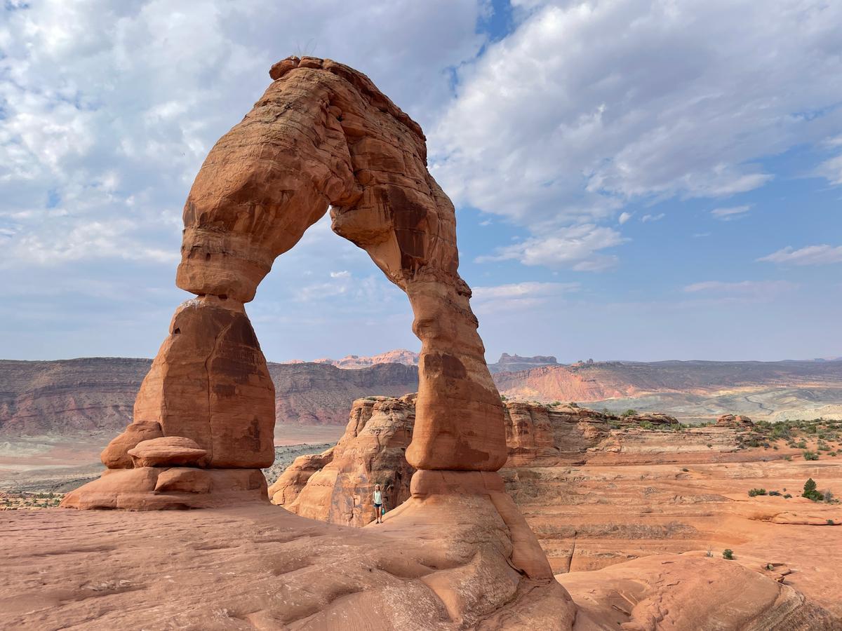 The author stands under Delicate Arch at Arches National Park in Utah. (Janna Graber)