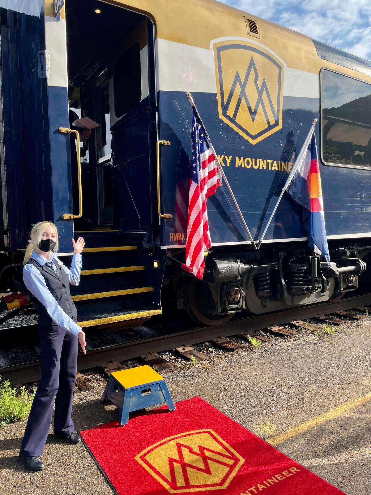 An attendant offers a welcome to the Rocky Mountaineer. (Janna Graber)