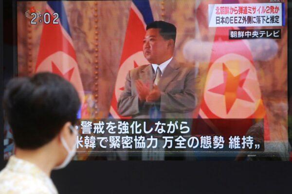 A man walks past a TV screen showing North Korean leader Kim Jong Un, in Tokyo, on Sept. 15, 2021. (Koji Sasahara/AP Photo)