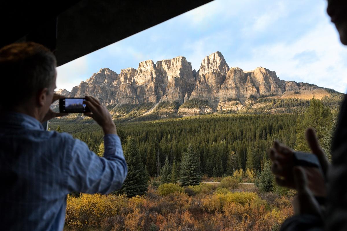 A guest takes photos from the GoldLeaf outdoor viewing platform. (Rocky Mountaineer)