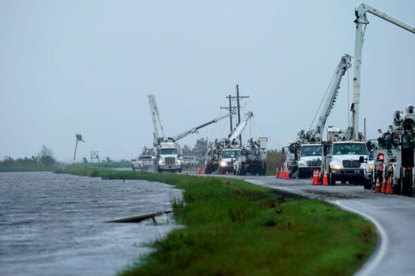 Utility crews replace power poles destroyed by Hurricane Ida as Tropical Storm Nicholas approaches in Pointe-aux-Chenes, La., on Sept. 14, 2021. (Gerald Herbert/AP Photo)