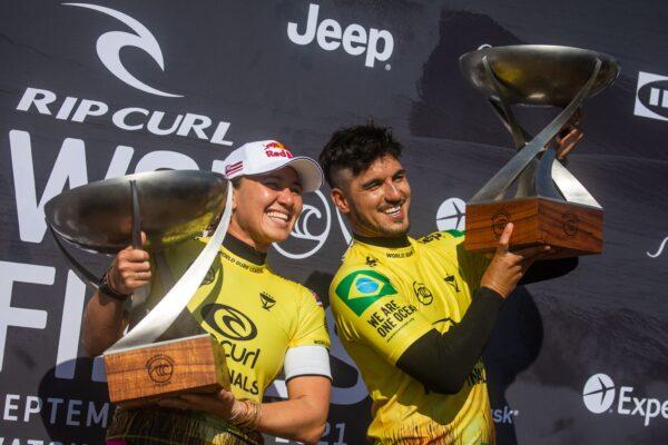 Brazilian surfer Gabriel Medina (R) and U.S. surfer Carissa Moore celebrate their world title after winning the men's and women's finals, respectively, of the Rip Curl World Surf League at Lower Trestles in San Clemente, Calif., on Sept. 14, 2021. (Apu Gomes/AFP via Getty Images)