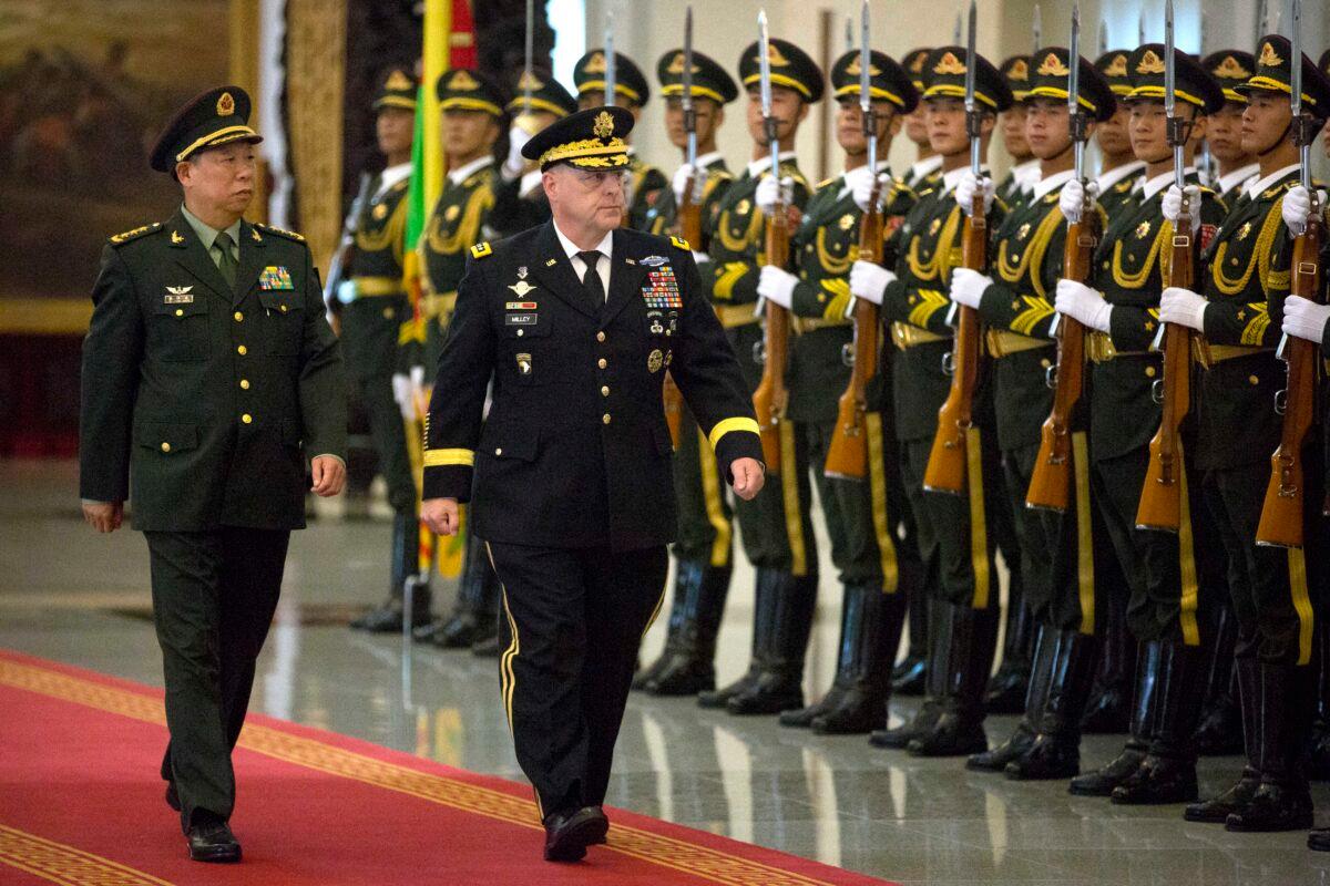 China's People's Liberation Army (PLA) Gen. Li Zuocheng (L) and US Army Chief of Staff Gen. Mark Milley (C) review an honor guard during a welcome ceremony at the Bayi Building in Beijing on Aug. 16, 2016. (Mark Schiefelbein/AFP via Getty Images)