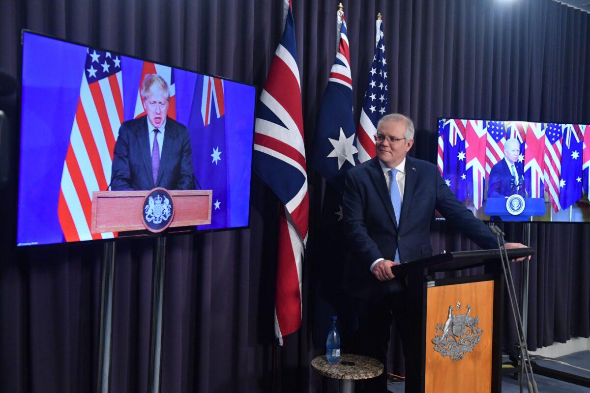 Britain’s Prime Minister Boris Johnson, Australia’s Prime Minister Scott Morrison, and U.S. President Joe Biden at a joint press conference via AVL from The Blue Room at Parliament, in Canberra, Australia, on Sept. 16, 2021. (Mick Tsikas/AAP Image)