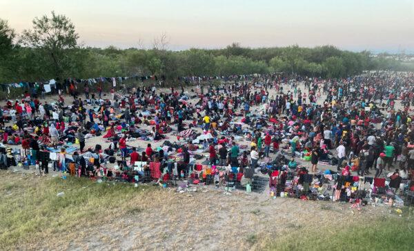Thousands of illegal immigrants gather near the international bridge after crossing the Rio Grande, in Del Rio, Texas, on Sept. 16, 2021. (Charlotte Cuthbertson/The Epoch Times)