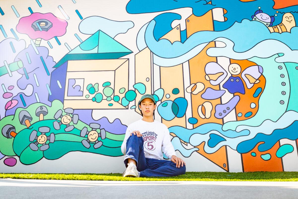 Roy Kim stands in front of the New Wave mural at the Atrium Hotel in Irvine, Calif. on Sept. 8, 2021. (John Fredricks/The Epoch Times)
