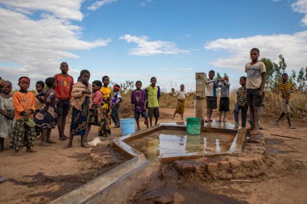 Villagers use their new well built by Water Wells for Africa in Khobwe Village 2, Malawi, on July 6, 2021. (John Fredricks/The Epoch Times)