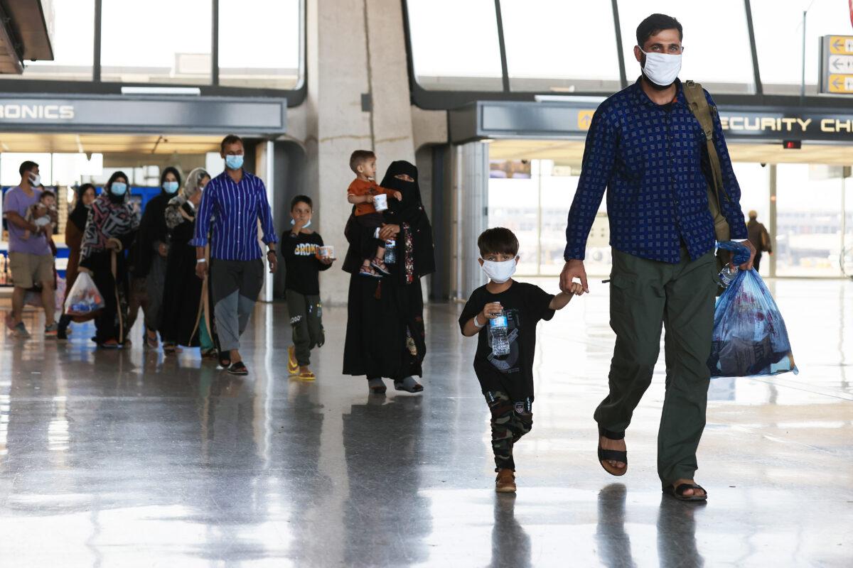 Refugees arrive at Dulles International Airport after being evacuated from Kabul following the Taliban takeover of Afghanistan, in Dulles, Va., on Aug. 27, 2021. (Chip Somodevilla/Getty Images)