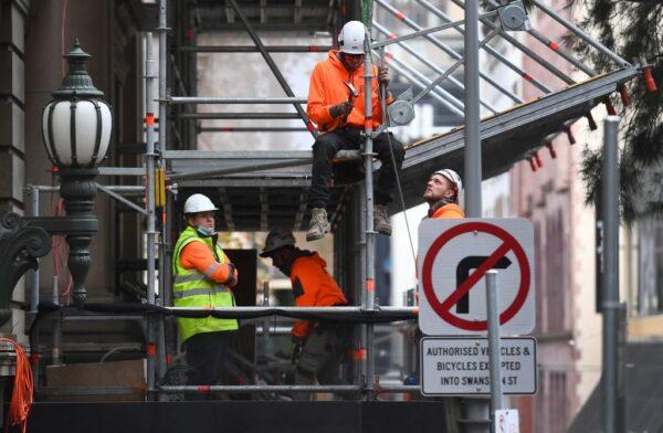 Construction workers work on a building in Melbourne, Australia, on May 28, 2021. (William West/ Getty Images)