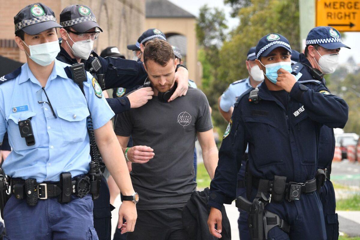 Police detain a man in Sydney, following calls for a protest rally amid the COVID-19 pandemic, on Sept. 18, 2021. (Saeed Khan/AFP via Getty Images)