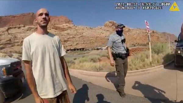 In this screenshot from a police camera video, Brian Laundrie talks to a police officer after police pulled over the van he was traveling in with his girlfriend, Gabrielle “Gabby” Petito, near the entrance to Arches National Park, Utah, on Aug. 12, 2021. (The Moab Police Department via AP)