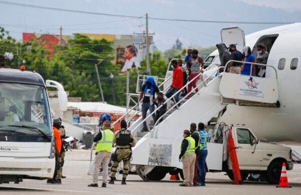 Haitians who were deported from the United States deplane at the Toussaint Louverture International Airport, in Port au Prince, Haiti, on Sept. 19, 2021. (AP Photo/Joseph Odelyn)