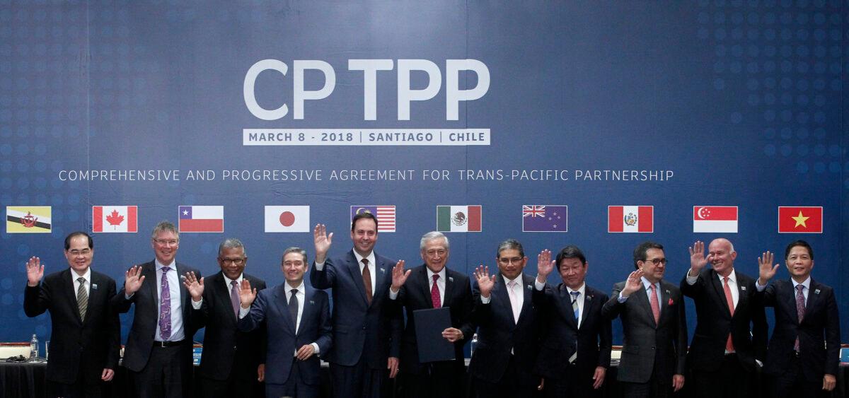 (L-R) Trade or foreign ministers of Singapore, New Zealand, Malaysia, Canada, Australia, Chile, Brunei, Japan, Mexico, Peru, and Vietnam pose for an official picture after signing the rebranded 11-nation Pacific trade pact Comprehensive and Progressive Agreement for Trans-Pacific Partnership (CPTPP) in Santiago, on March 8, 2018. (Claudio Reyes/AFP via Getty Images)