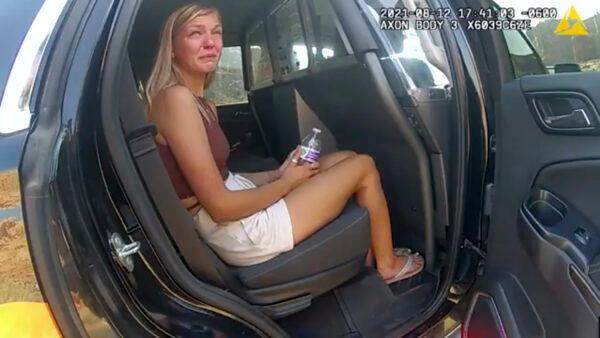In this screenshot from a police camera video, Gabrielle “Gabby” Petito talks to a police officer after police pulled over the van she was traveling in with her boyfriend, Brian Laundrie, near the entrance to Arches National Park, Utah, on Aug. 12, 2021. (The Moab Police Department via AP)