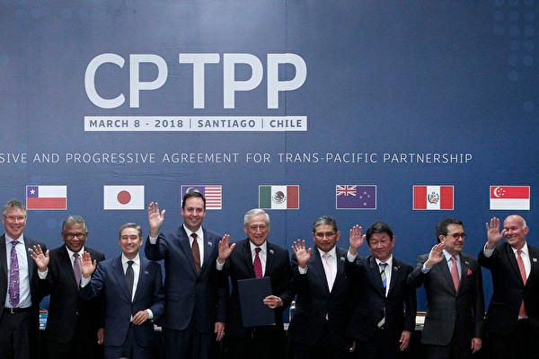 (Left to right) Trade or foreign ministers of Singapore, New Zealand, Malaysia, Canada, Australia, Chile, Brunei, Japan, Mexico, Peru, and Vietnam pose for an official picture after signing the rebranded 11-nation Pacific trade pact Comprehensive and Progressive Agreement for Trans-Pacific Partnership (CPTPP) in Santiago, Chile, on March 8, 2018. (Claudio Reyes/AFP via Getty Images)