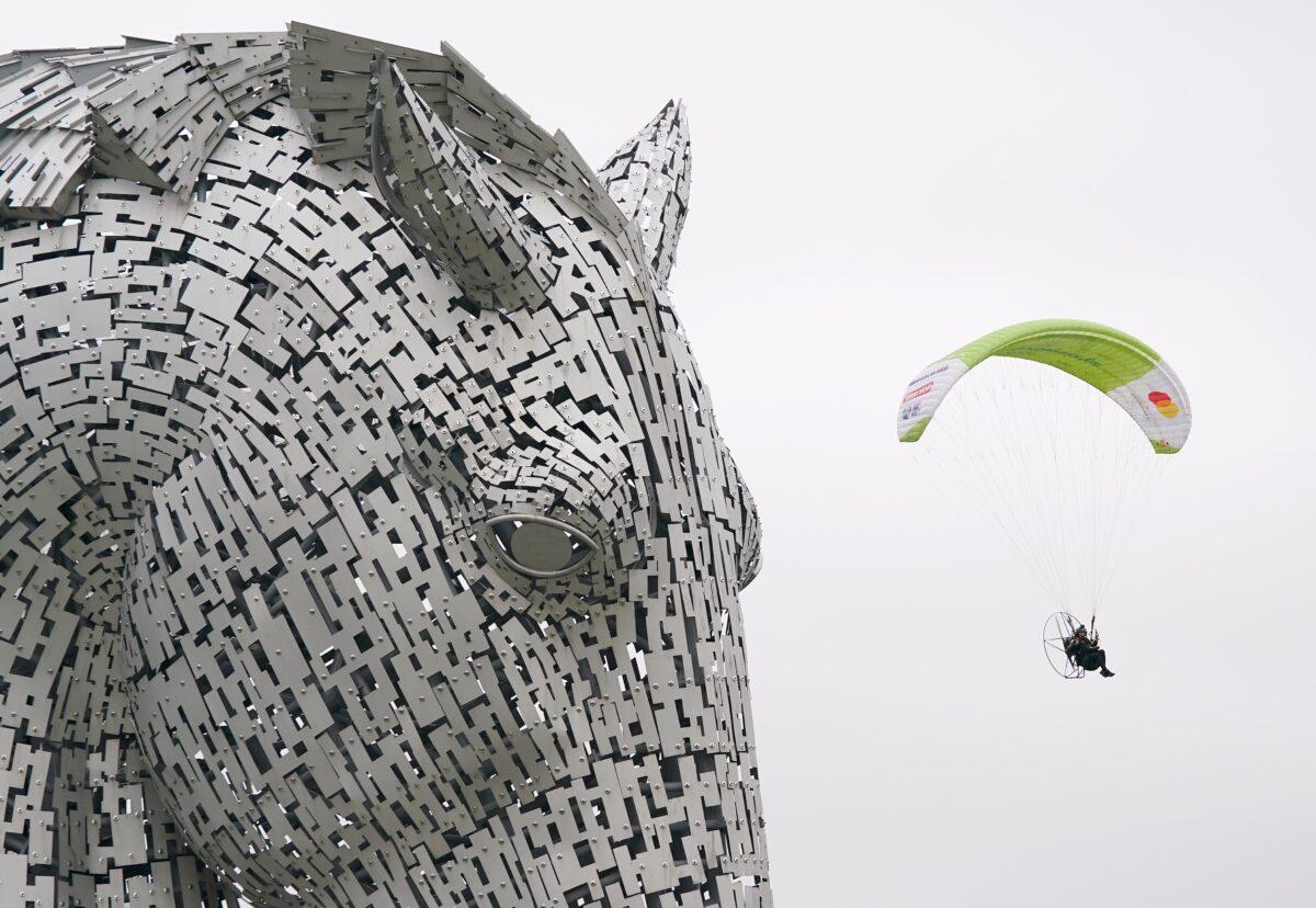 Paramotorist Sacha Dench in flight at the Kelpies near Falkirk as she arrives back into Scotland, on Sept. 3, 2021. (Andrew Milligan/PA)