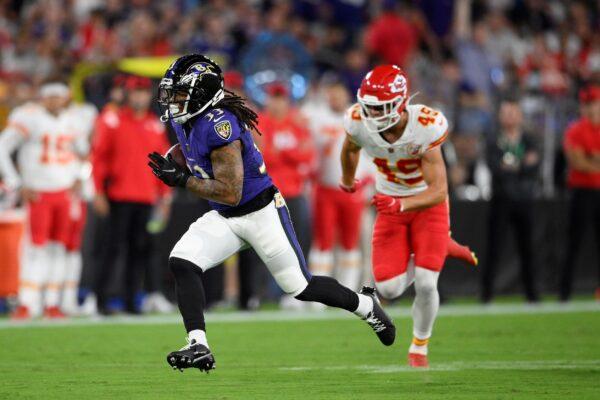 Baltimore Ravens running back Devonta Freeman (L) rushes past Kansas City Chiefs defensive back Daniel Sorensen in the first half of an NFL football game, in Baltimore, Md., on Sept. 19, 2021. (Nick Wass/AP Photo)