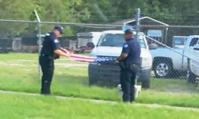 Photos Show Sheriff’s Deputies Folding American Flag Saved From Barbwire Fence After Hurricane Ida