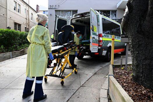 Health workers take out stretchers from an ambulance at the Hardi Aged Care Nursing Home Facility in Summers Hill suburb of Sydney, Australia, on Aug. 2, 2021 (Saeed Khan/AFP via Getty Images)