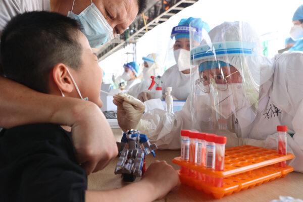 A child undergoes a nucleic acid test for the COVID-19 in Xiamen, southern China's Fujian Province on Sept. 18, 2021. (STR/AFP via Getty Images)