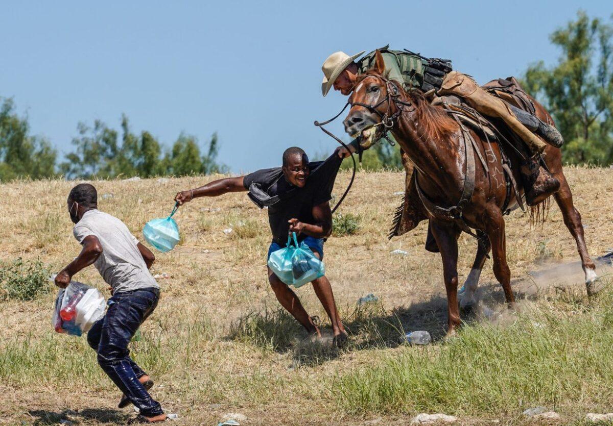 A United States Border Patrol agent on horseback tries to stop a Haitian illegal alien from entering an encampment on the banks of the Rio Grande near the Acuna Del Rio International Bridge in Del Rio, Texas on September 19, 2021. (PAUL RATJE/AFP via Getty Images)