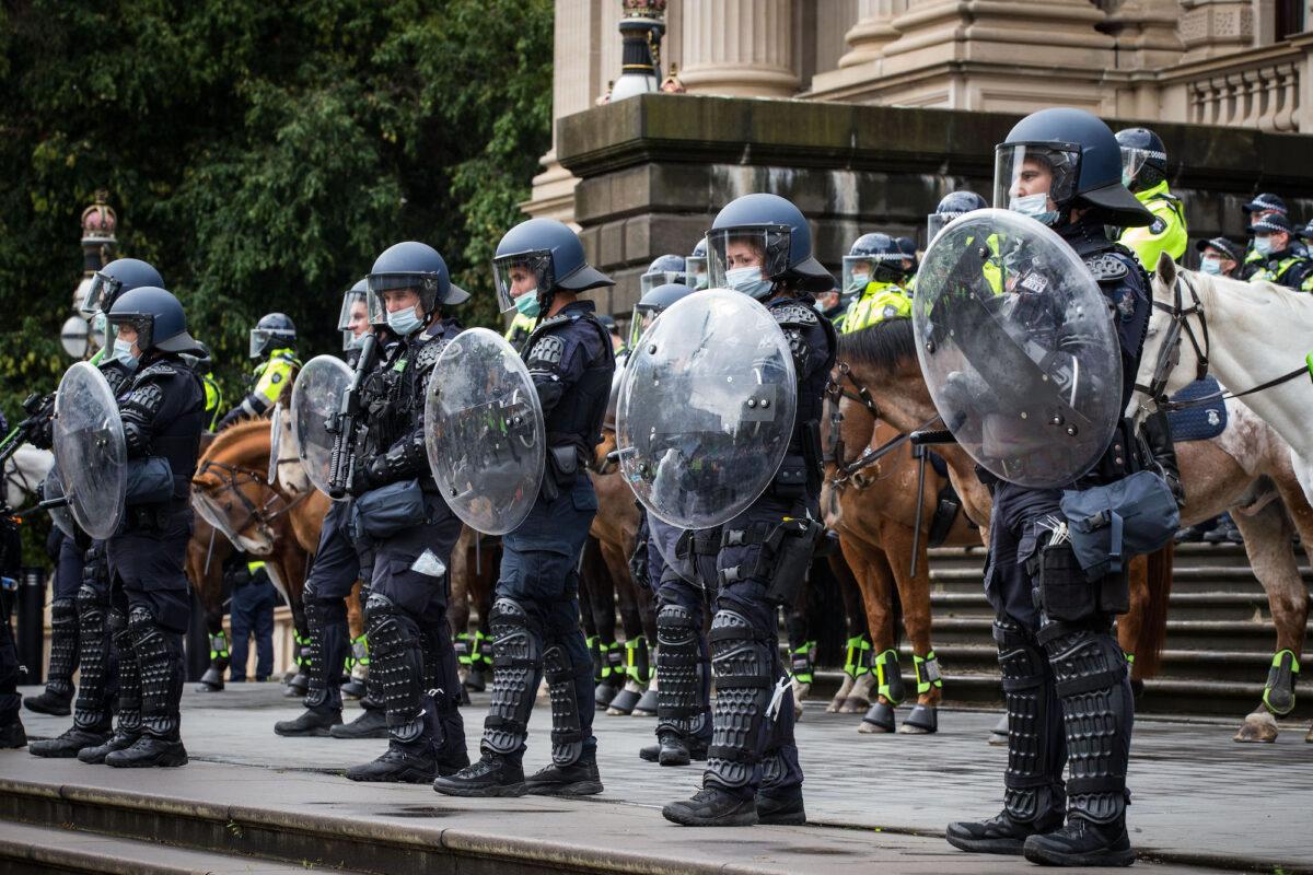 Members of Victoria Police stand on the steps of Parliament House in Melbourne, Australia, on Sept. 21, 2021. (Darrian Traynor/Getty Images)