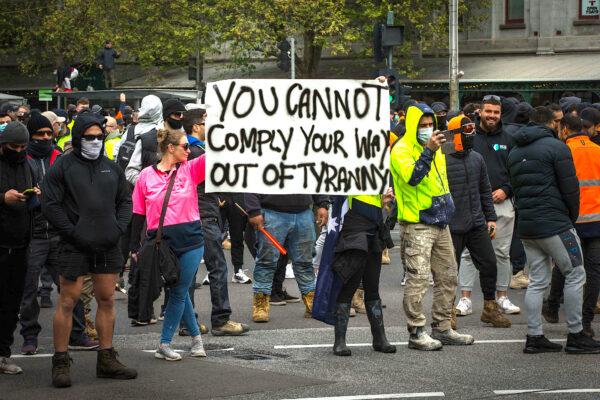 Protesters hold a sign that reads 'You cannot comply your way out of tyranny' during demonstrations against mandatory COVID-19 vaccines and restrictions in Melbourne, Australia, on Sept. 21, 2021. (Darrian Traynor/Getty Images)