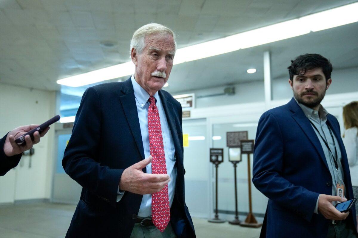 Sen. Angus King (I-Maine) talks with reporters as he walks through the Senate subway on his way to a vote at the U.S. Capitol on June 21, 2021. (Drew Angerer/Getty Images)
