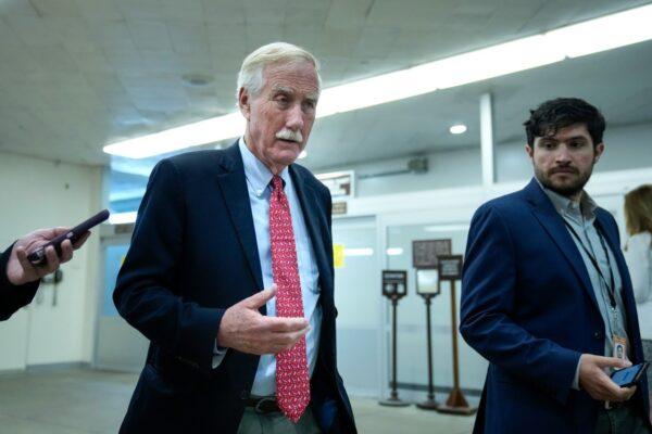 Sen. Angus King (I-Maine) talks with reporters as he walks through the Senate subway on his way to a vote at the Capitol in Washington, on June 21, 2021. (Drew Angerer/Getty Images)